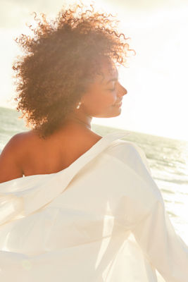 woman wearing white linen at the beach