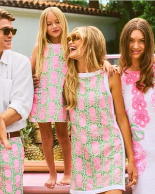 models wearing pink and green dresses