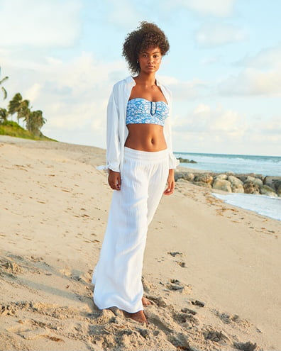 model wearing white coverup top and bottom