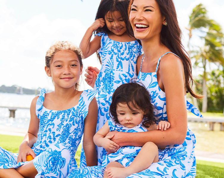 models wearing matching blue and white printed dresses