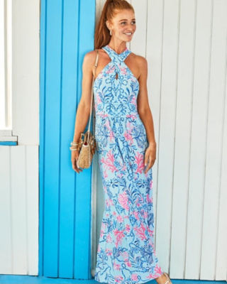 model wearing long blue and pink dress with cross top
