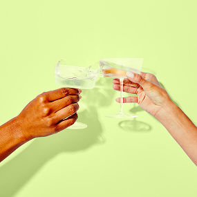 two hands cheering with coupes