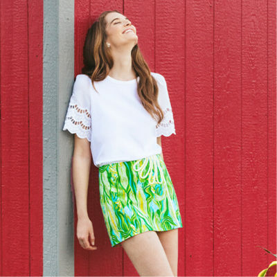 model in yellow and green skort