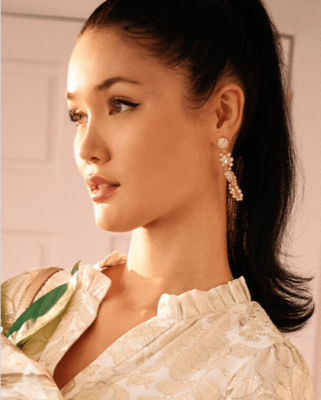 model wearing gold earrings