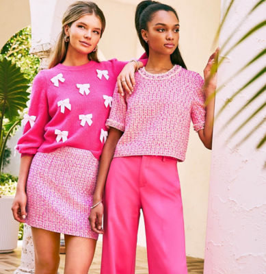 Two woman wearing coordinating pink outfits