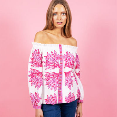 Woman wearing a white and pink printed top