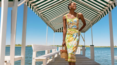 Woman wearing a printed top and skirt