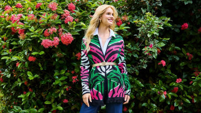 Woman wearing a green pink and black sweater