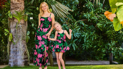 Woman and little girl wearing matching patterened dresses