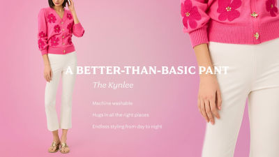 Woman wearing a pink sweater and white pants