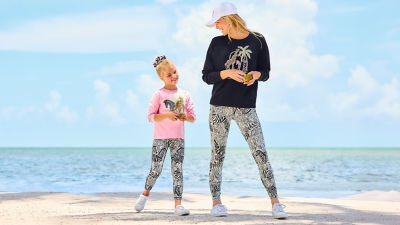 Woman and little girl wearing sweatshirts and leggings