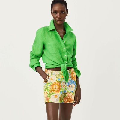 Woman wearing a green top and printed shorts