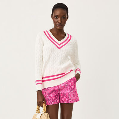 Woman wearing a white sweater with pink shorts