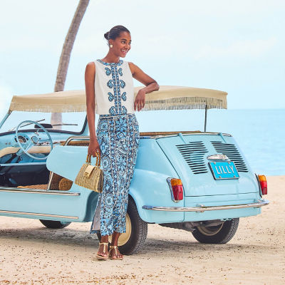Women wearing a white printed top and a blue printed maxi skirt