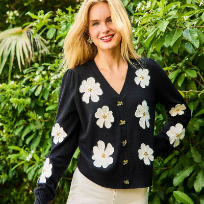 Womean wearing a black cardigan with white florals