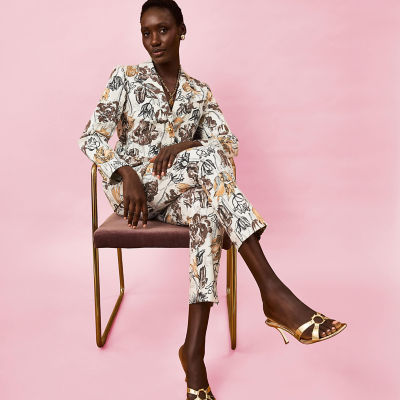 Woman wearing a brown printed blazer and pants