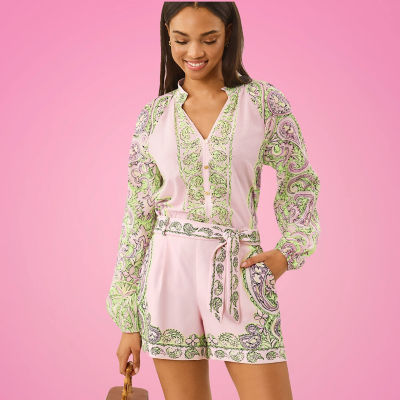 Woman wearing a light pink and green printed top and shorts