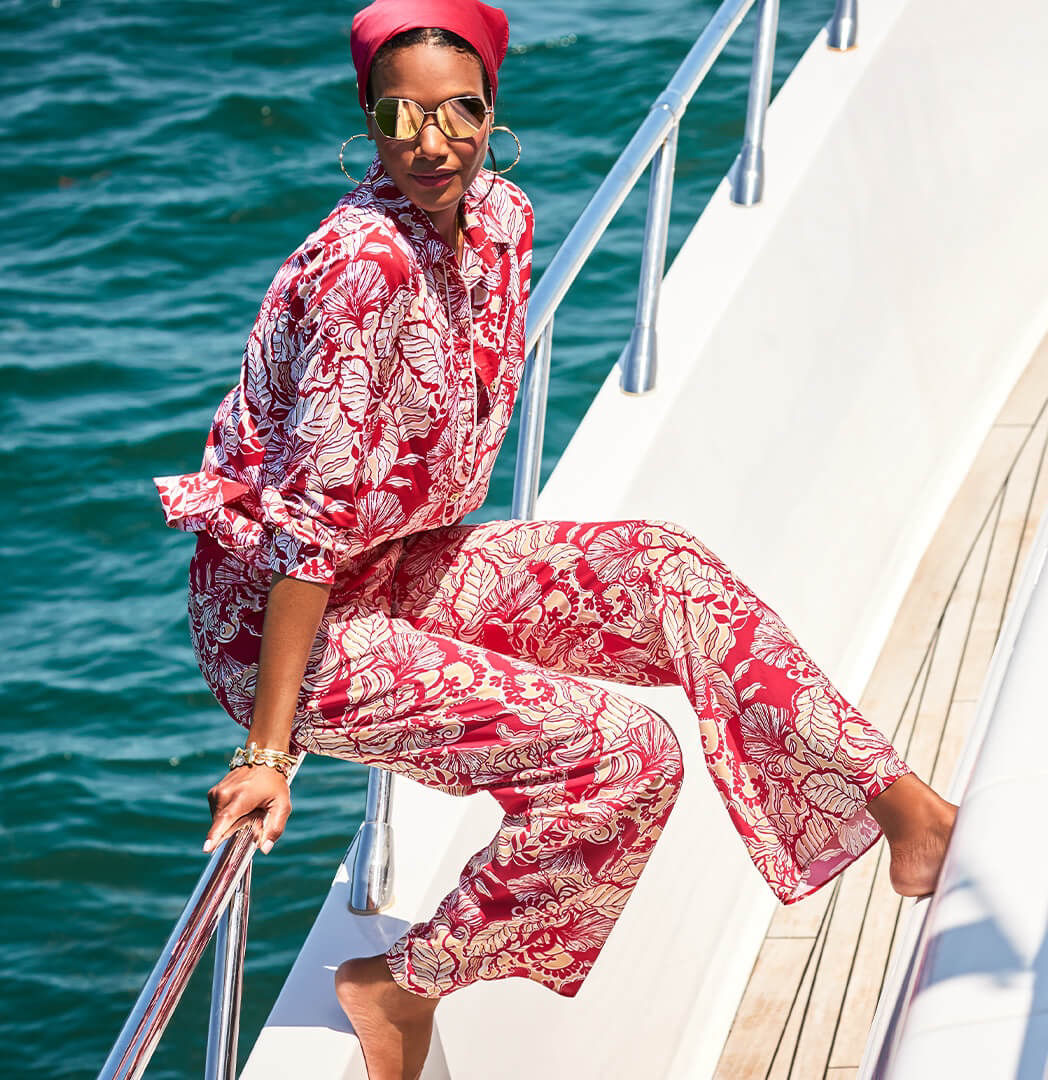 Model wearing the Giavana Tunic and the Bal Harbour Palazzo Pant in the Poinsettia Red Island Vibes print