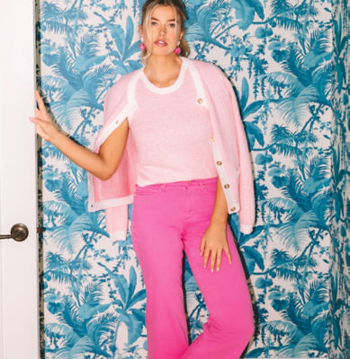 Woman wearing a pink and white sweater set with hot pink pants