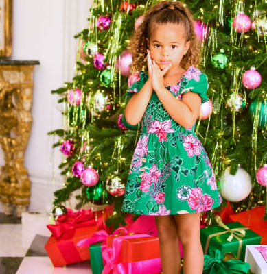 Woman and little girls wearing matching pink and green printed dresses