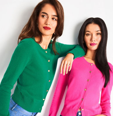 Woman wearing a green cardigan and another wearing a pink cardigan