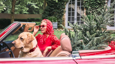 Woman wearing a red sweater and head wrap