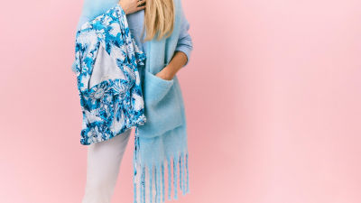 Woman holding blue printed pajamas