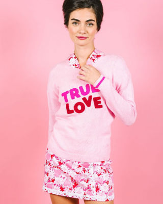 Women wearing a pink sweater and pink printed skirt