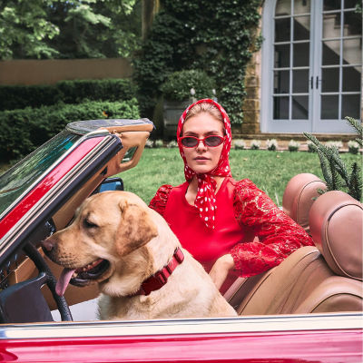 Woman wearing a red top and head wrap