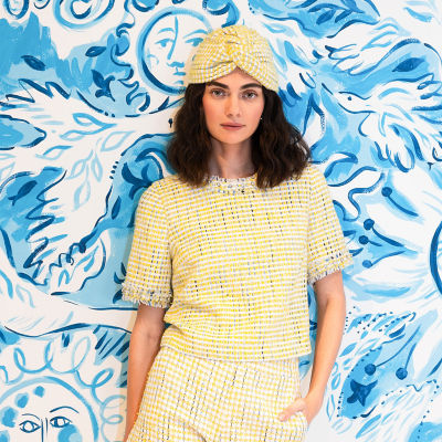 Woman wearing a yellow boucle top