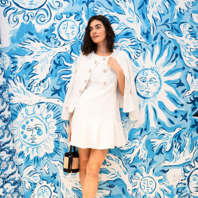 Woman wearing a white boucle dress and jacket