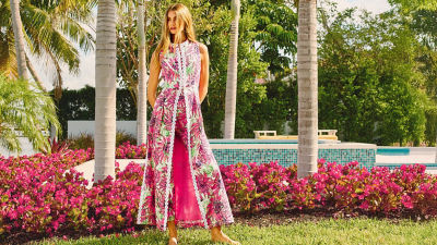 Woman wearing a long pink printed duster vest