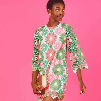 Woman wearing a pink and green lace dress