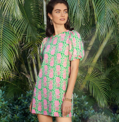 Woman wearing a green and pink printed dress