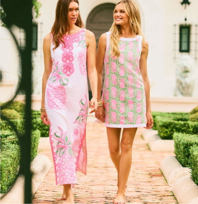 Two women wearing pink printed shift dresses