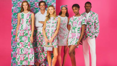 Group of people wearing pink and green printed outfits