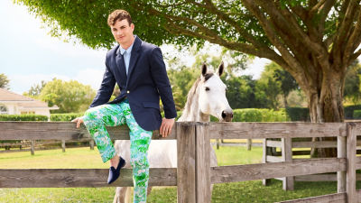 Man wearing a navy blazer and green printed pants