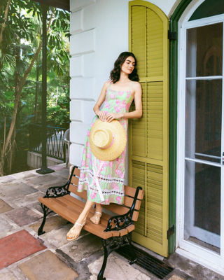 Woman wearing a pink and green printed dress