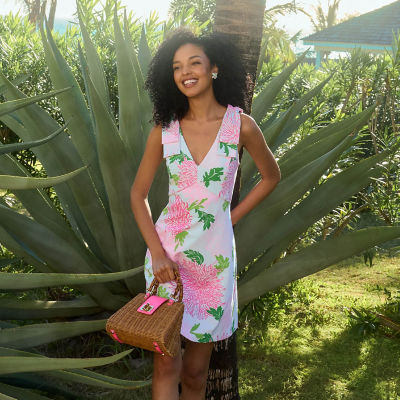 Woman wearing a white pink and green floral printed dress