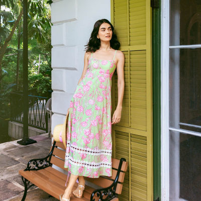 Woman wearing a long green and pink printed dress