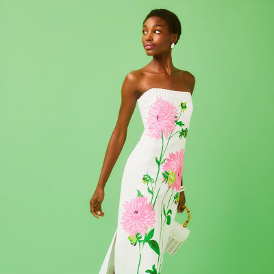 Woman wearing a white maxi dress with a floral design