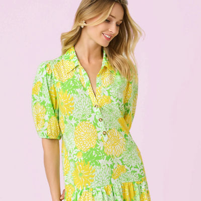 Woman wearing a green and yellow floral dress
