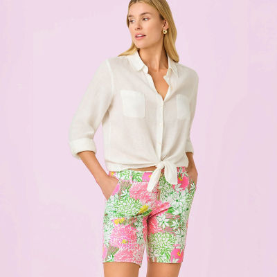 Woman wearing a white shirt and pink and green printed shorts