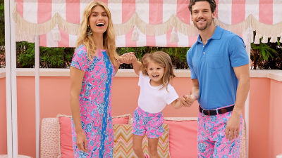 Family wearing matching pink and blue printed outfits