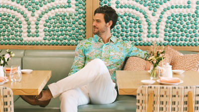 Man wearing a green and blue printed shirt
