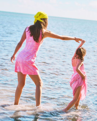 Woman and little girl wearing pink dresses