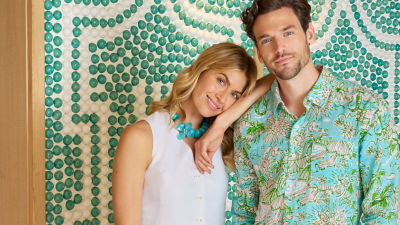 Man wearing a green and blue printed shirt and woman wearing a white vest