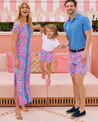 Family wearing matching pink and blue printed outfits