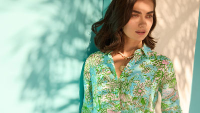 Woman wearing a blue printed linen top and shorts