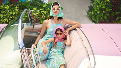 Woman and little girl wearing matching blue printed dresses